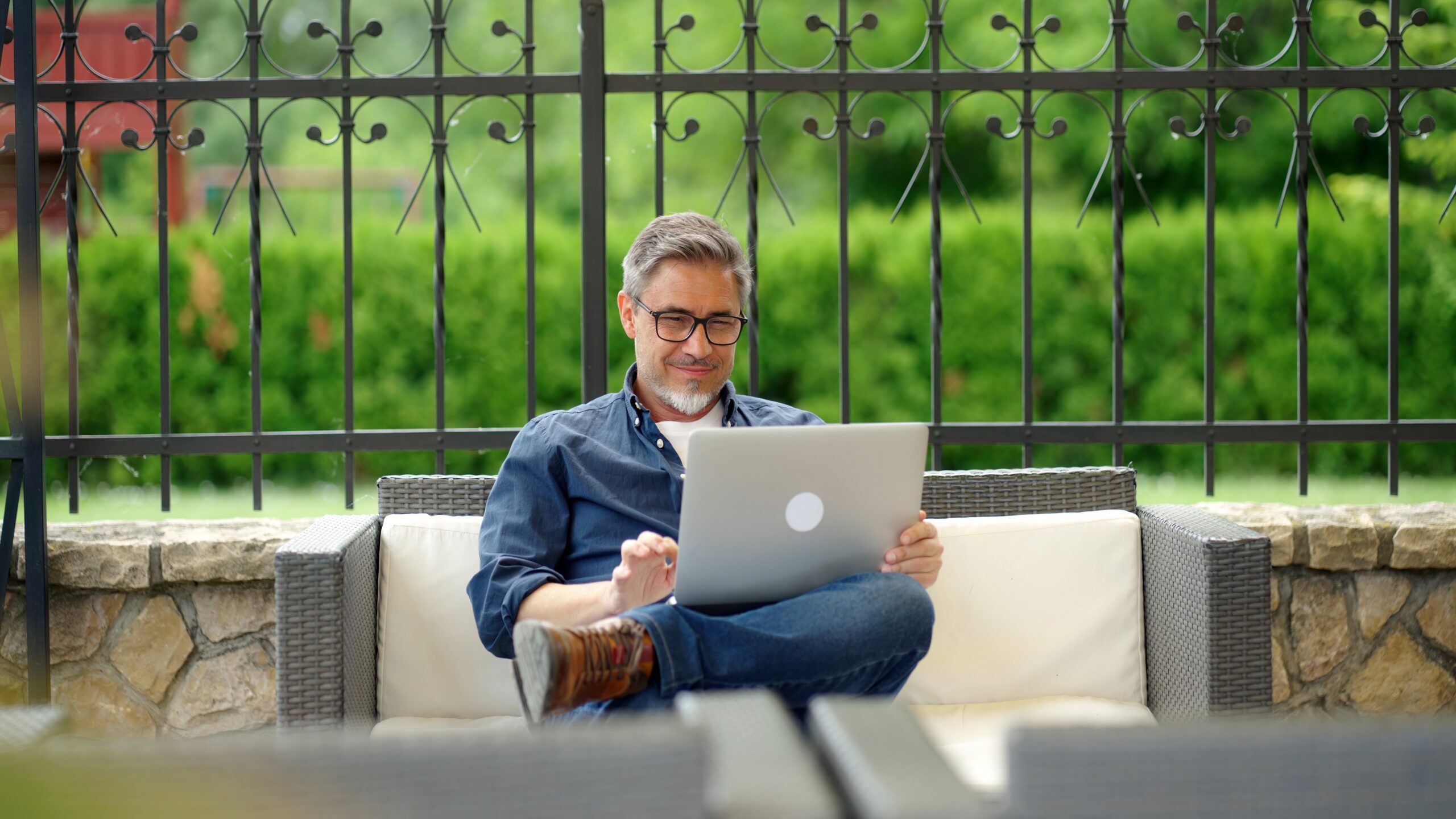 Man sitting outside while reviewing the quarterly financial reports.