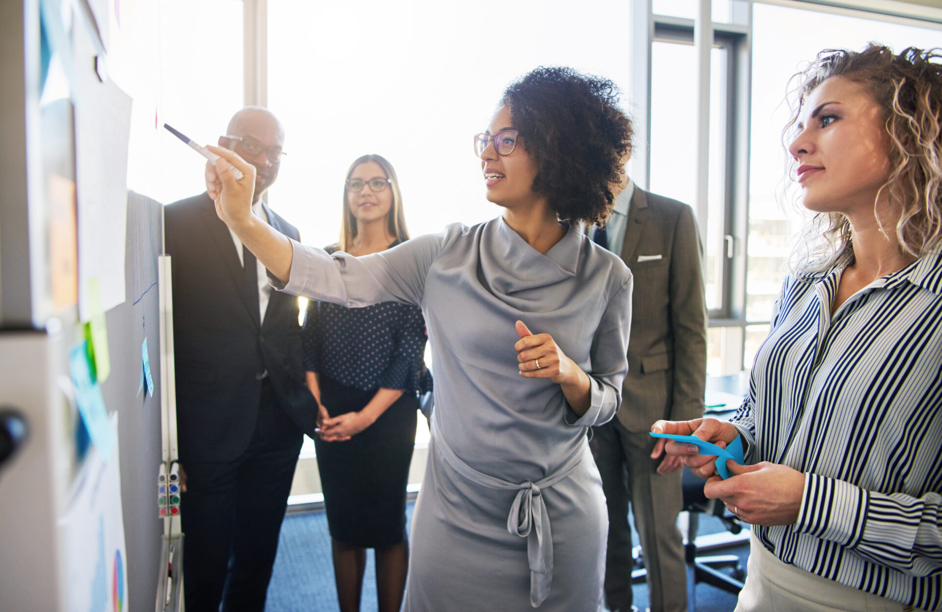 CFO, CIO and team members brainstorming finance digital transformation in a modern office