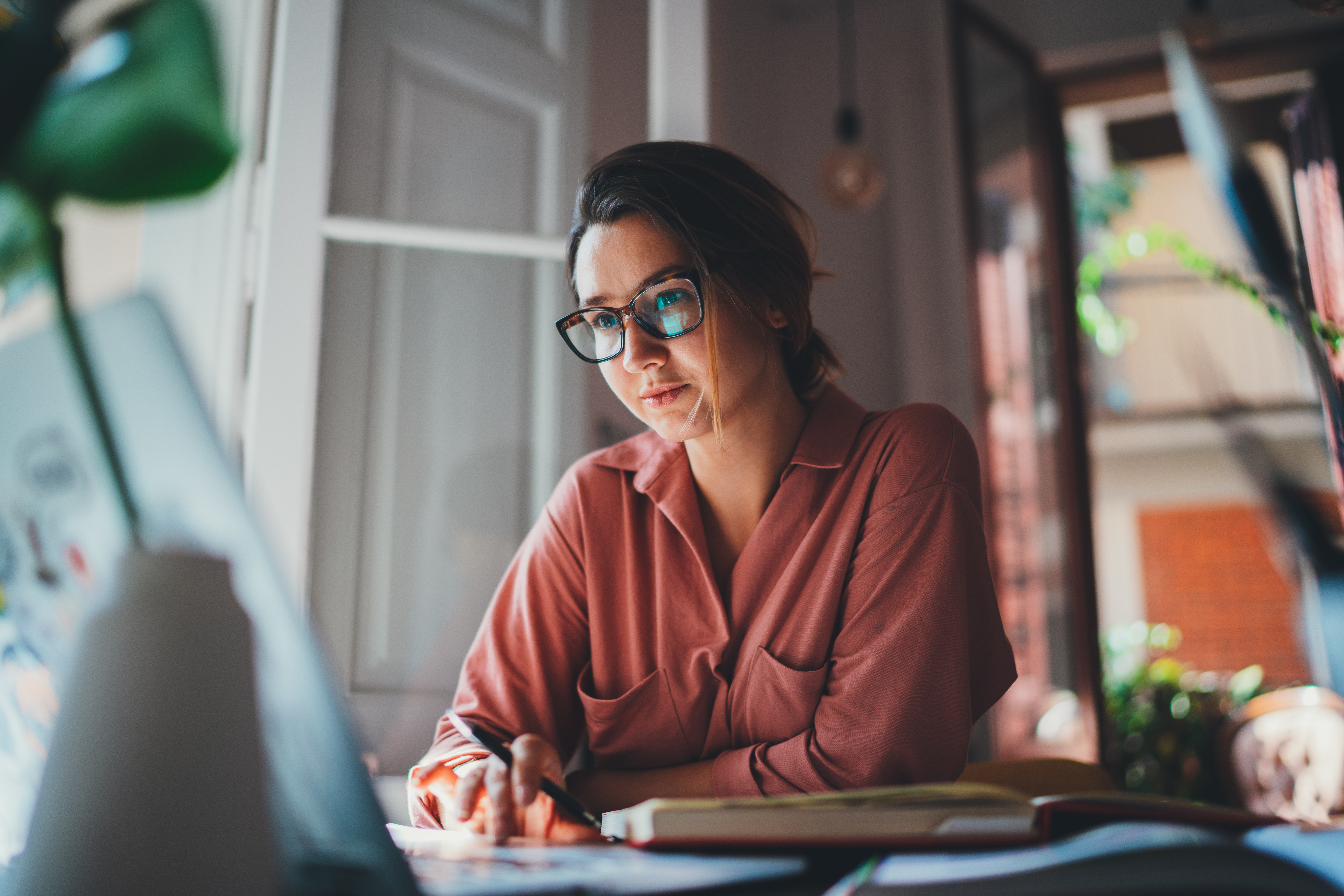 Pretty young woman an advertising copywriter in eyeglasses working at home using laptop, female graphic designer working in modern studio, Networking Freelancer Businesswoman Designer Entrepreneur