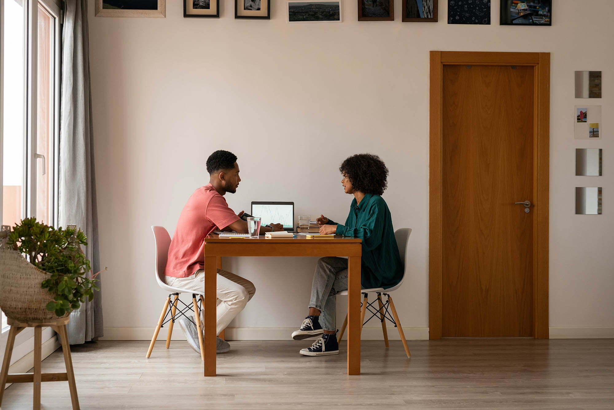 Technology leaders collaborating in home office on intercompany accounting tasks with laptop