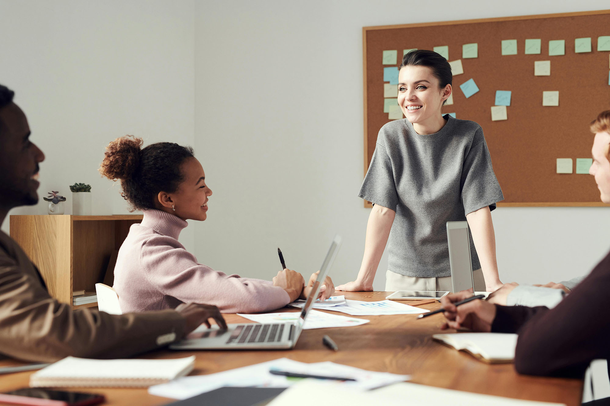 Team of coworkers collaborating in meeting led by manager to review financial close management tasks